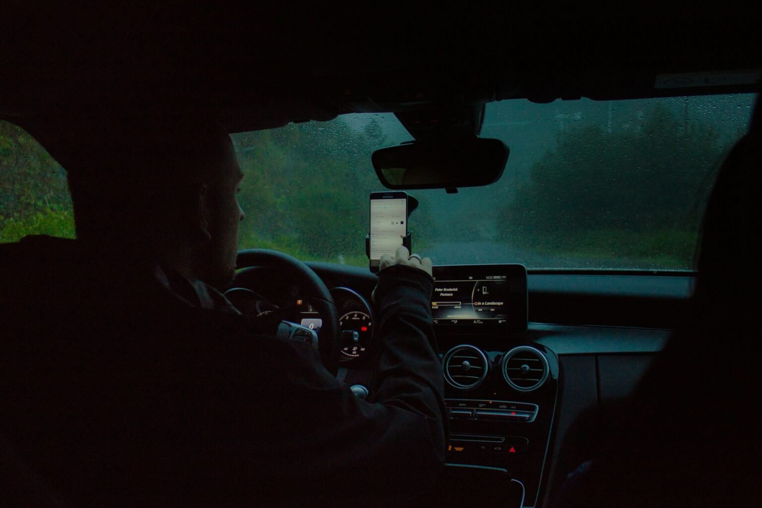 Driver using a phone inside a car during an insurance-related communication